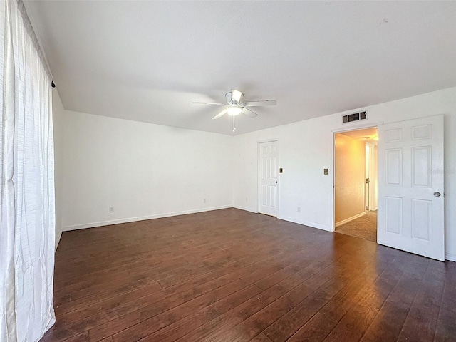 9201 Tudor Dr Unit C212, Tampa, FL 33615 - spare room featuring dark wood-style floors, ceiling fan, and baseboards