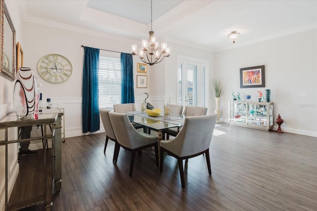 216 High St, Tarpon Springs, FL 34689 - dining space featuring a chandelier, dark wood-type flooring, crown molding, and wainscoting