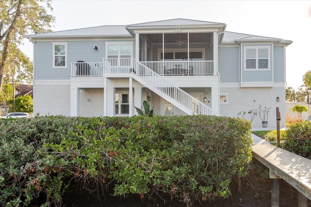 216 High St, Tarpon Springs, FL 34689 - rear view of property with stairs, stucco siding, a ceiling fan, and metal roof