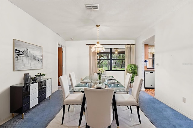 56 Bay Woods Dr, Safety Harbor, FL 34695 - dining area with a chandelier, light tile patterned floors, and baseboards