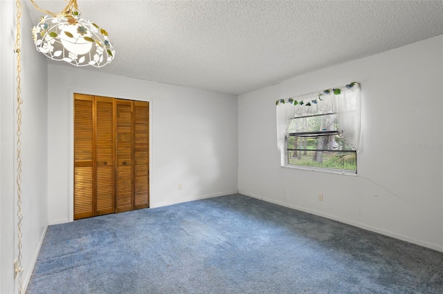56 Bay Woods Dr, Safety Harbor, FL 34695 - unfurnished bedroom featuring carpet flooring, a closet, and a textured ceiling