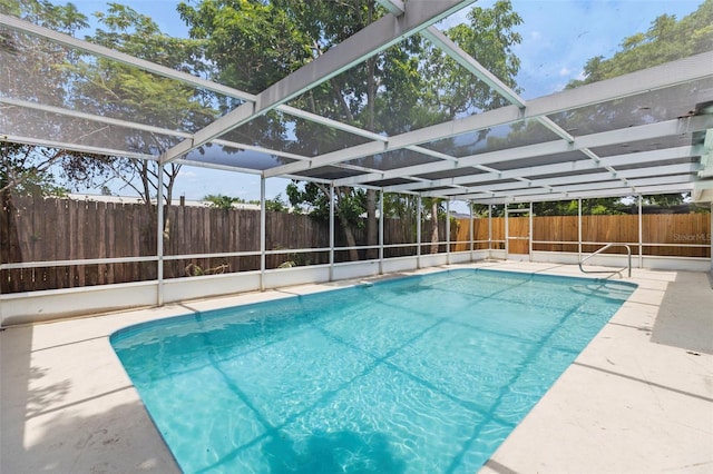 9241 Cochise Ln, Port Richey, FL 34668 - view of swimming pool with a fenced backyard, glass enclosure, and a patio area