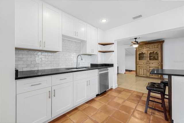 3310 W Ballast Point Blvd, Tampa, FL 33611 - kitchen featuring dishwasher, a sink, open shelves, a ceiling fan, and dark countertops