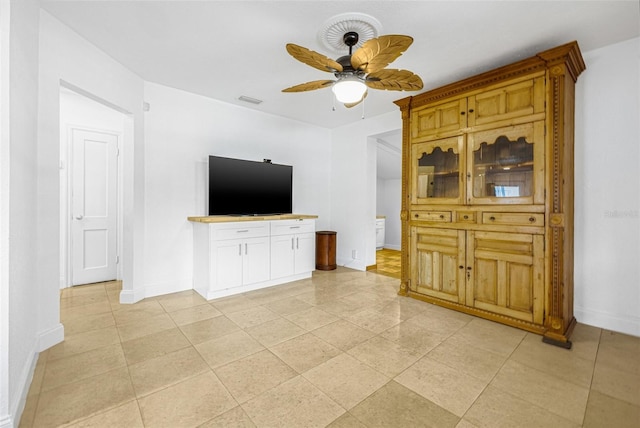 3310 W Ballast Point Blvd, Tampa, FL 33611 - unfurnished living room with baseboards, ceiling fan, and light tile patterned floors