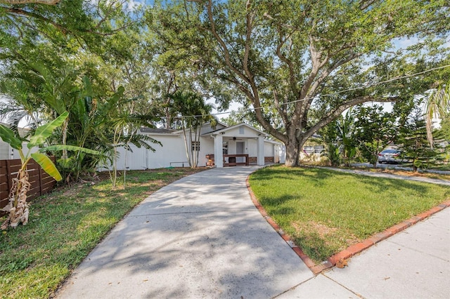 3310 W Ballast Point Blvd, Tampa, FL 33611 - view of front facade featuring concrete driveway and a front yard