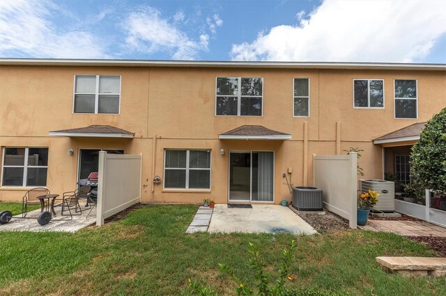 11615 Mango Ridge Blvd Unit 39, Seffner, FL 33584 - rear view of house featuring stucco siding, a patio area, a lawn, and central AC