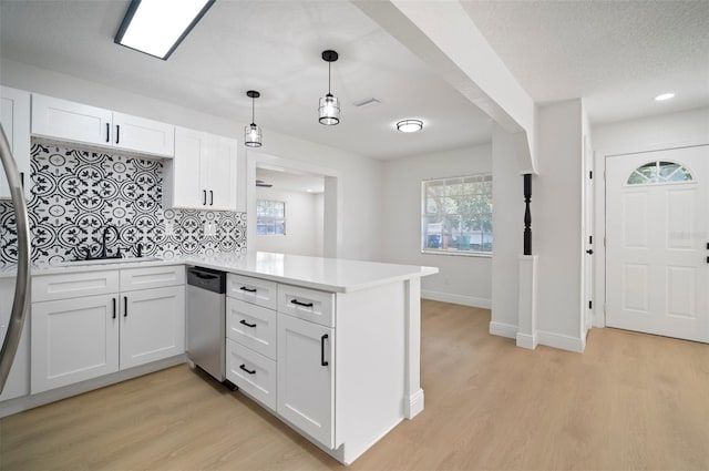5405 S Sellas St, Tampa, FL 33611 - kitchen with dishwasher, a peninsula, decorative backsplash, light wood-type flooring, and recessed lighting