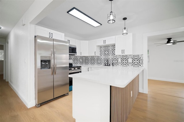 5405 S Sellas St, Tampa, FL 33611 - kitchen with stainless steel appliances, light wood finished floors, backsplash, a sink, and white cabinets