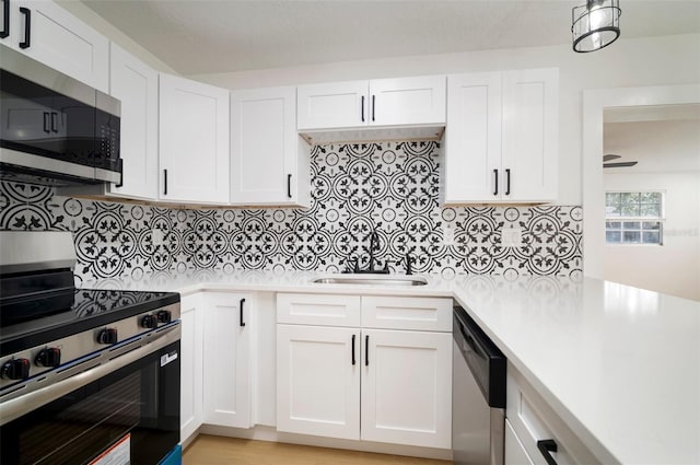 5405 S Sellas St, Tampa, FL 33611 - kitchen with appliances with stainless steel finishes, a sink, light countertops, and white cabinets