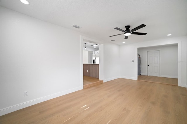 5405 S Sellas St, Tampa, FL 33611 - unfurnished living room with ceiling fan, light wood-style floors, baseboards, water heater, and recessed lighting