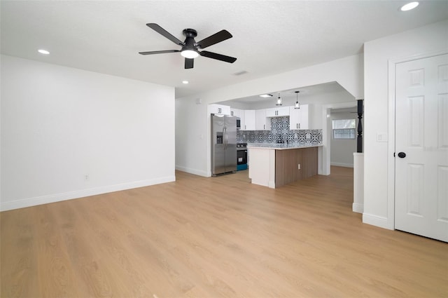 5405 S Sellas St, Tampa, FL 33611 - unfurnished living room featuring a ceiling fan, baseboards, light wood-style floors, and recessed lighting