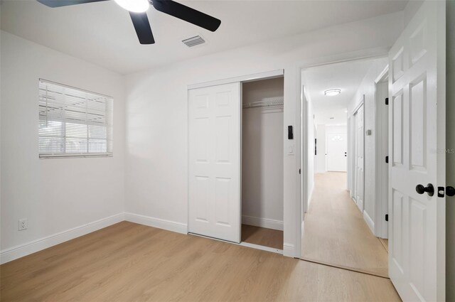 5405 S Sellas St, Tampa, FL 33611 - unfurnished bedroom with light wood finished floors, baseboards, a closet, and ceiling fan