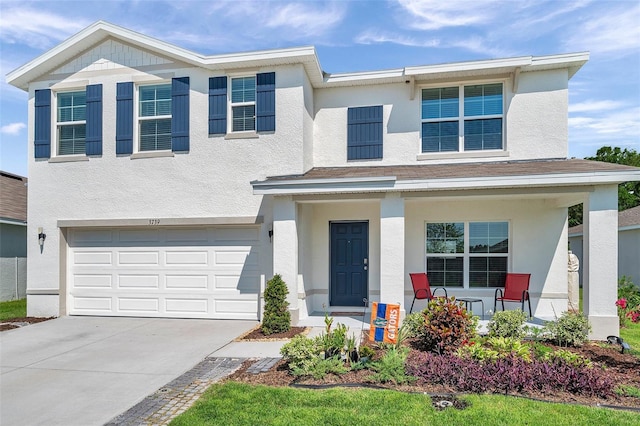 3739 Capri Coast Dr, Plant City, FL 33565 - view of front of house with covered porch, concrete driveway, an attached garage, and stucco siding