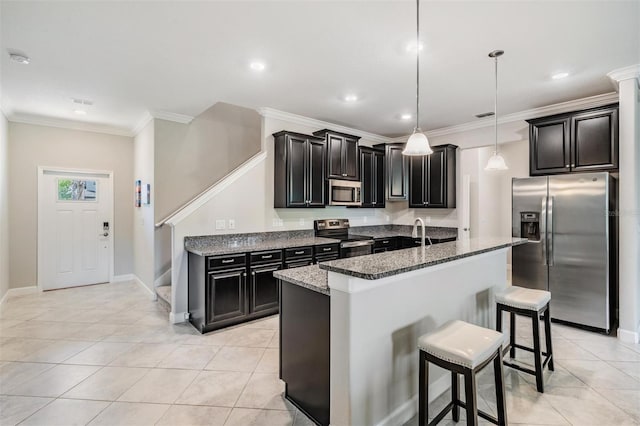1396 White Fox Run, Lutz, FL 33549 - kitchen featuring stainless steel appliances, a breakfast bar area, stone countertops, an island with sink, and dark cabinets