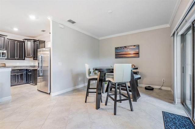 1396 White Fox Run, Lutz, FL 33549 - dining area featuring crown molding, baseboards, and light tile patterned floors