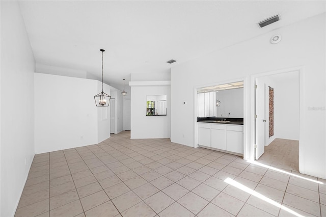 3447 Killdeer Pl, Palm Harbor, FL 34685 - spare room featuring a chandelier, light tile patterned floors, and a sink