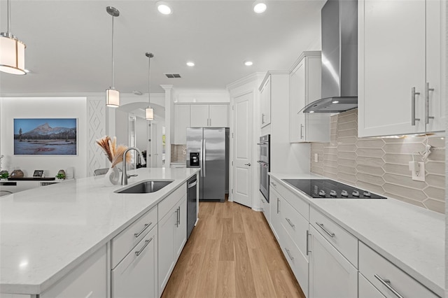 9271 Rally Spring Loop, Wesley Chapel, FL 33545 - kitchen featuring stainless steel appliances, wall chimney exhaust hood, a sink, white cabinets, and light wood-style flooring