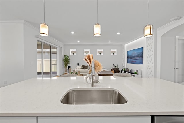 9271 Rally Spring Loop, Wesley Chapel, FL 33545 - kitchen featuring open floor plan, a sink, light stone counters, hanging light fixtures, and recessed lighting