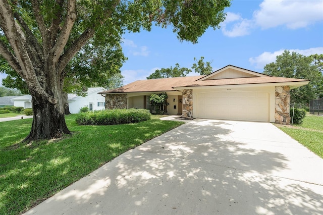 8105 Valley Stream Ln, Hudson, FL 34667 - ranch-style home with stone siding, an attached garage, a front lawn, and driveway