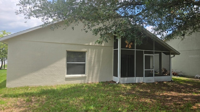1416 Silverthorn Dr, Orlando, FL 32825 - back of property featuring a sunroom, a yard, and stucco siding