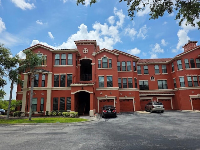 2713 Via Murano Unit 210, Clearwater, FL 33764 - view of property featuring an attached garage and driveway