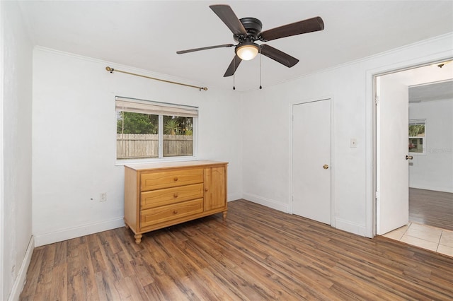 130 E Pendleton Ave, Eustis, FL 32726 - unfurnished bedroom featuring wood finished floors, ornamental molding, baseboards, and a ceiling fan
