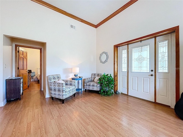 13341 Hexam Rd, Weeki Wachee, FL 34613 - entryway with light wood-style floors, ornamental molding, and a high ceiling