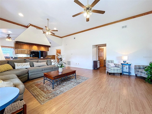 13341 Hexam Rd, Weeki Wachee, FL 34613 - living area with a ceiling fan, high vaulted ceiling, ornamental molding, and wood finished floors