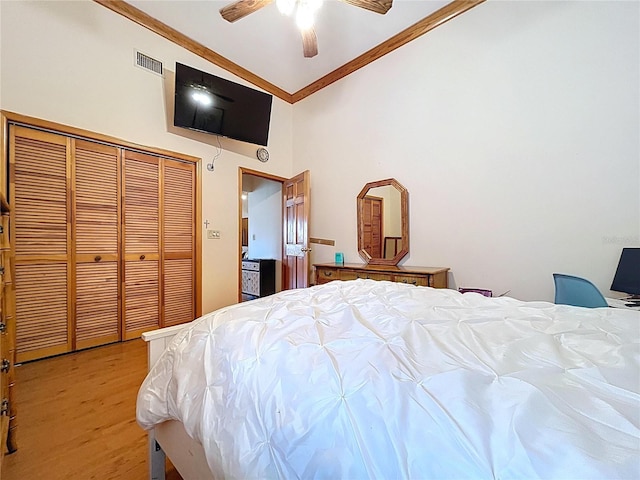 13341 Hexam Rd, Weeki Wachee, FL 34613 - bedroom with ornamental molding, light wood-style flooring, a closet, high vaulted ceiling, and a ceiling fan