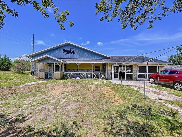 13341 Hexam Rd, Weeki Wachee, FL 34613 - view of front of house with a garage, a front yard, driveway, and a porch