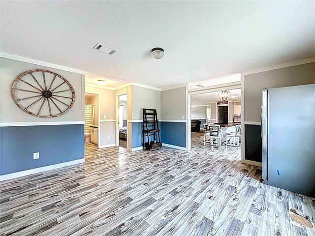 8851 C 469, Center Hill, FL 33514 - living room with wood finished floors, a textured ceiling, and ornamental molding