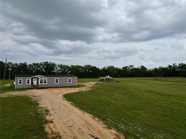 8851 C 469, Center Hill, FL 33514 - manufactured / mobile home featuring dirt driveway, a front lawn, and view of wooded area