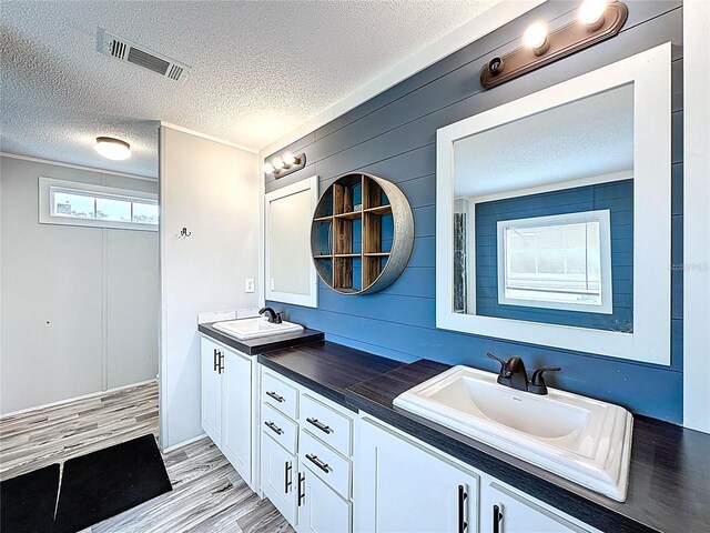 8851 C 469, Center Hill, FL 33514 - full bathroom with a textured ceiling, double vanity, and wood finished floors