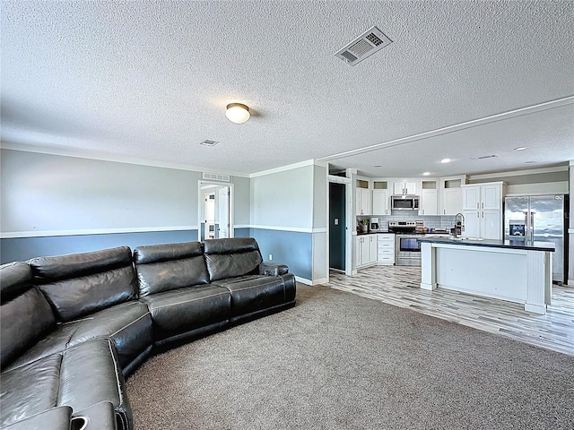 8851 C 469, Center Hill, FL 33514 - living area with light colored carpet, a textured ceiling, and recessed lighting