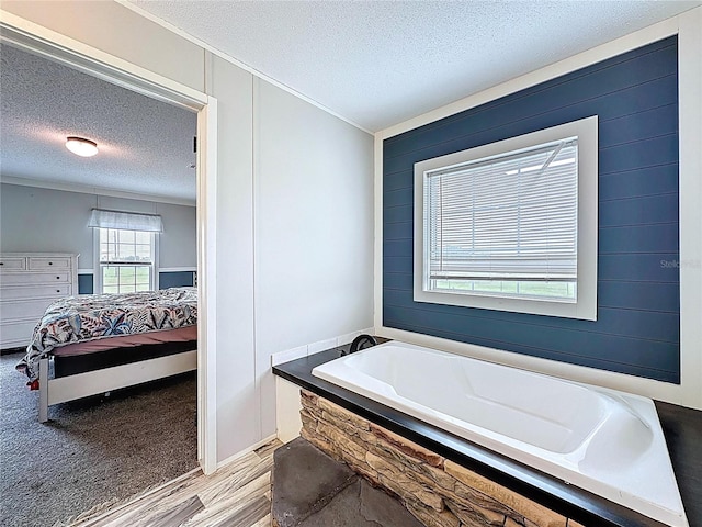 8851 C 469, Center Hill, FL 33514 - full bathroom with ensuite bath, a textured ceiling, wood finished floors, a bath, and ornamental molding
