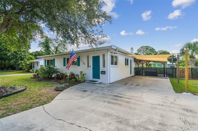 1529 Essex Dr N, Saint Petersburg, FL 33710 - view of front of property featuring a carport, driveway, and stucco siding