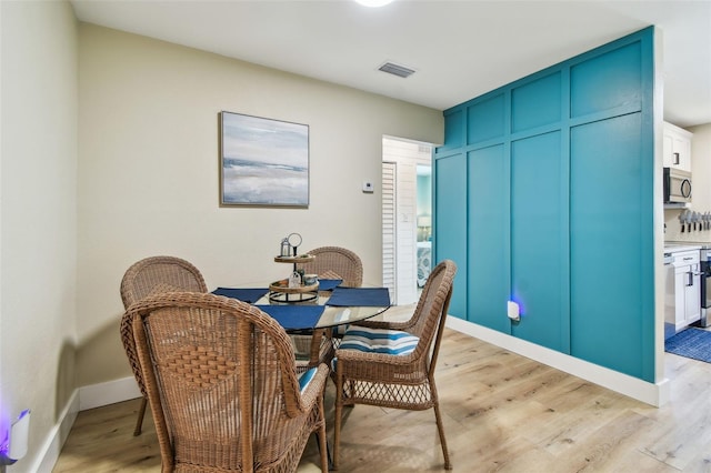1529 Essex Dr N, Saint Petersburg, FL 33710 - dining room with light wood-type flooring and baseboards