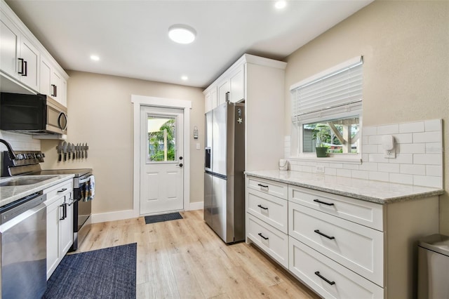 1529 Essex Dr N, Saint Petersburg, FL 33710 - kitchen featuring stainless steel appliances, backsplash, plenty of natural light, and recessed lighting