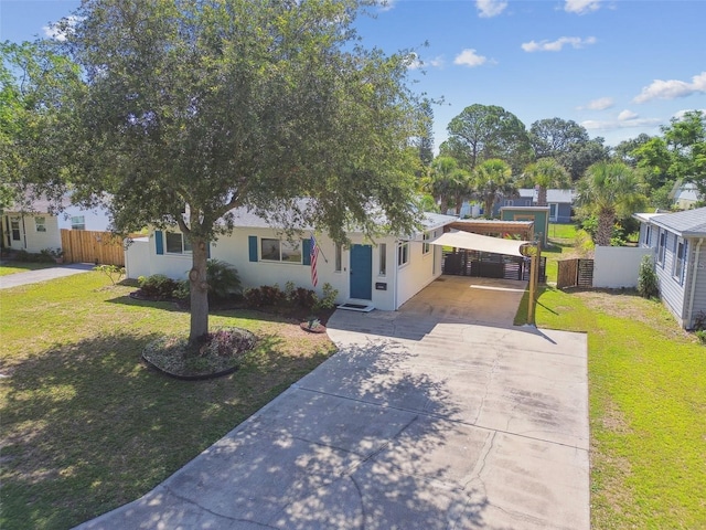 1529 Essex Dr N, Saint Petersburg, FL 33710 - view of front of property featuring driveway, a carport, and stucco siding