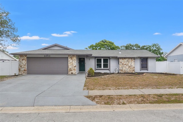 8010 Chickasaw Ln, Port Richey, FL 34668 - ranch-style house featuring stone siding, a garage, concrete driveway, and a shingled roof