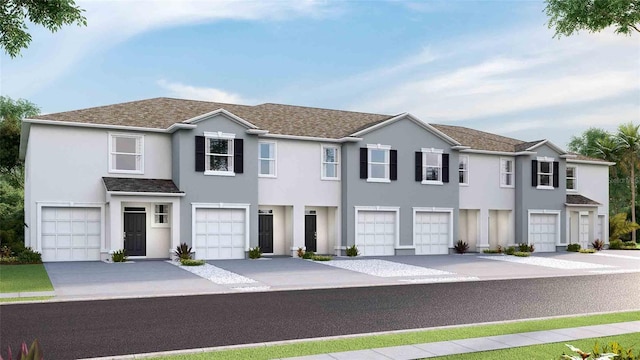 5112 Captain Davis Dr, Wimauma, FL 33598 - townhome / multi-family property with a garage, stucco siding, concrete driveway, and a shingled roof