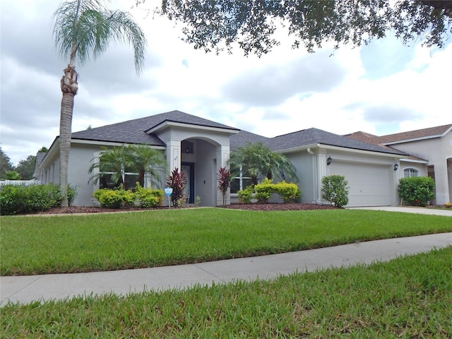 5815 Heronview Crescent Dr, Lithia, FL 33547 - ranch-style home featuring stucco siding, a garage, a front yard, and roof with shingles