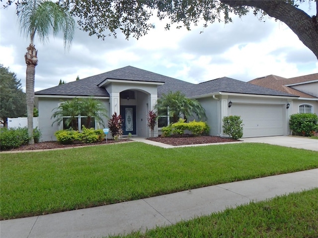 5815 Heronview Crescent Dr, Lithia, FL 33547 - ranch-style house with stucco siding, a garage, a shingled roof, a front yard, and concrete driveway