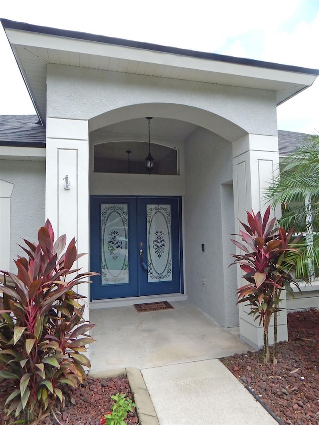 5815 Heronview Crescent Dr, Lithia, FL 33547 - property entrance featuring stucco siding, a shingled roof, and a porch