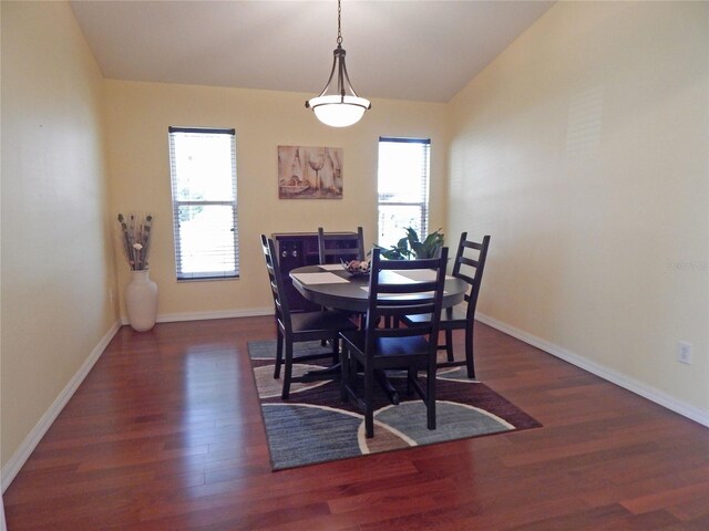 5815 Heronview Crescent Dr, Lithia, FL 33547 - dining room featuring wood finished floors, lofted ceiling, and baseboards
