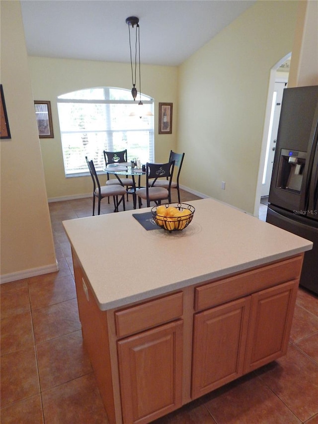 5815 Heronview Crescent Dr, Lithia, FL 33547 - kitchen featuring fridge with ice dispenser, tile patterned flooring, a center island, light countertops, and baseboards