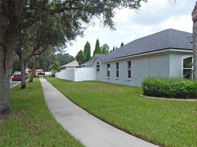 5815 Heronview Crescent Dr, Lithia, FL 33547 - view of side of property featuring stucco siding and roof with shingles