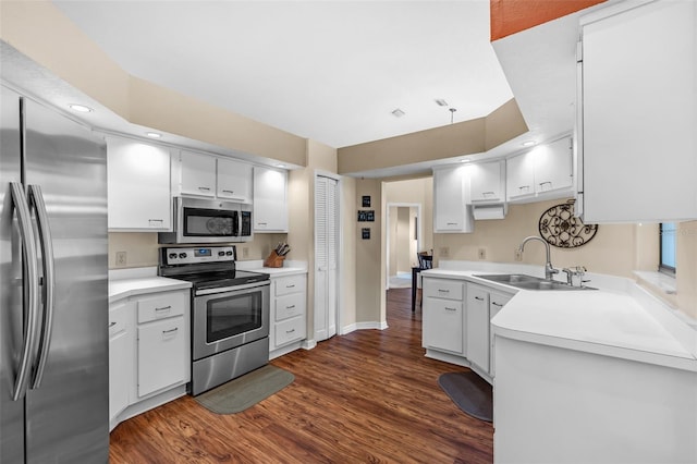 2921 SE 38th Pl, Ocala, FL 34480 - kitchen with stainless steel appliances, dark wood-style flooring, light countertops, white cabinetry, and recessed lighting