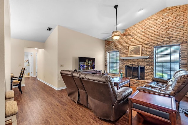 2921 SE 38th Pl, Ocala, FL 34480 - living area featuring lofted ceiling, plenty of natural light, a ceiling fan, wood finished floors, and brick wall