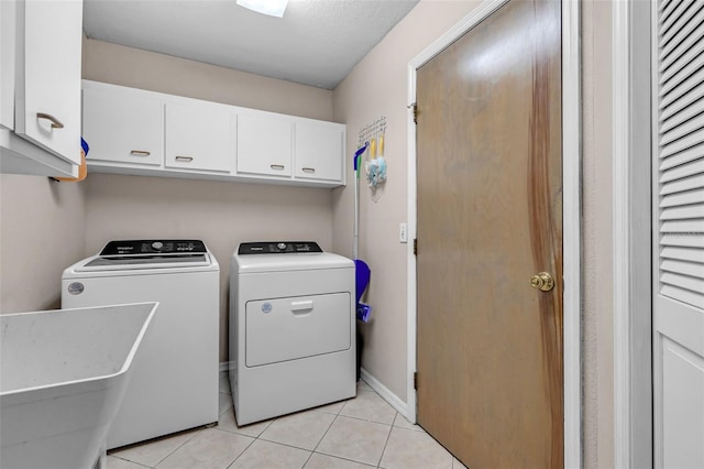 2921 SE 38th Pl, Ocala, FL 34480 - washroom with cabinet space, independent washer and dryer, and light tile patterned flooring